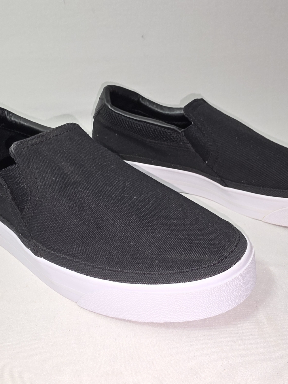 Nike Women's Black Slip-On Sneakers with White Sole